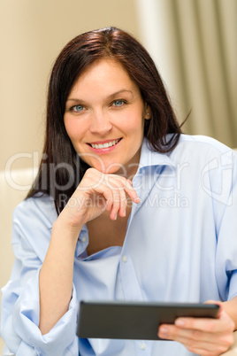 Confident smiling woman with digital tablet