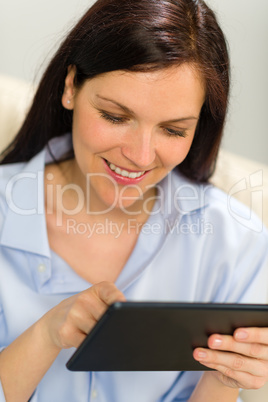 Portrait of smiling woman using digital tablet