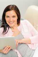Beautiful joyful woman holding digital tablet