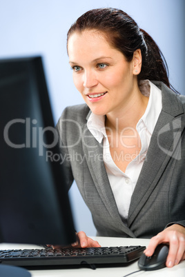 Smiling businesswoman working on her computer