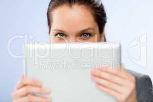 Woman holding digital tablet hiding her face