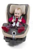 child in booster seat for a car in light background