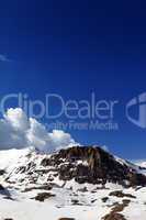 Rocks in snow and blue sky