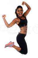 Woman in sportswear jumping with joy