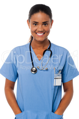 Young female doctor with hands in pocket