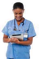 Female physician operating tablet pc