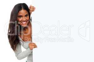Female model holding blank white ad board