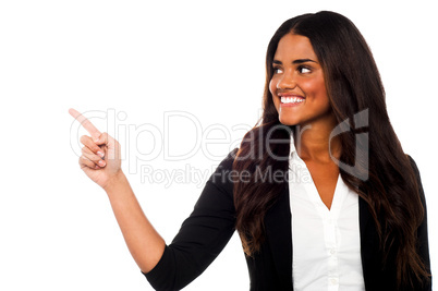 Corporate lady pointing towards copy space area