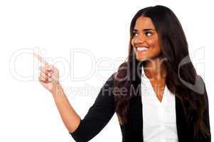 Corporate lady pointing towards copy space area