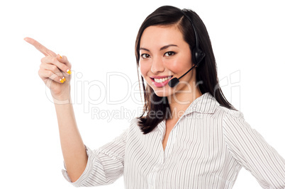 Asian call center executive pointing away