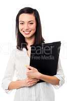 Female assistant holding business files