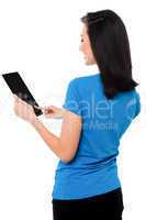 Smiling attractive girl operating touch pad device