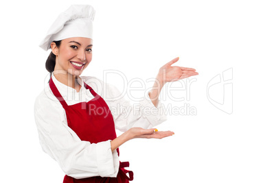 Female chef presenting something