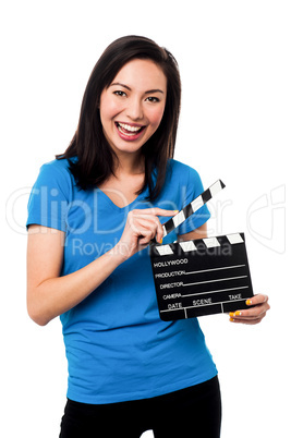 Young girl holding clapperboard