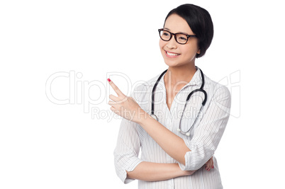 Female physician pointing and looking away