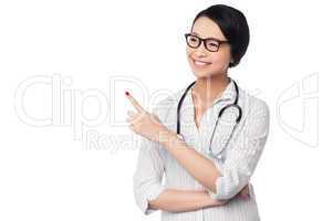 Female physician pointing and looking away