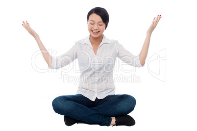 Pretty girl practicing meditation smilingly