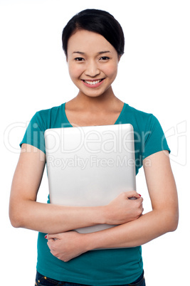 Smiling asian female posing with laptop