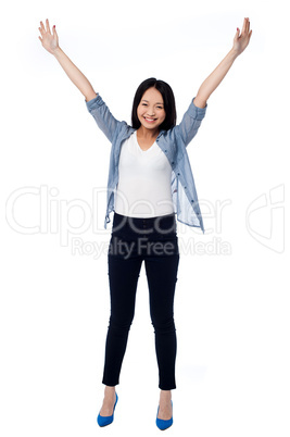 Joyous female raising arms in excitement