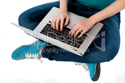 Cropped image of a girl working on laptop