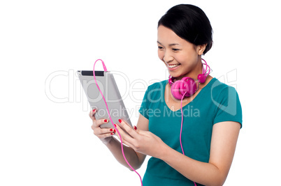 Adorable girl watching video on tablet device