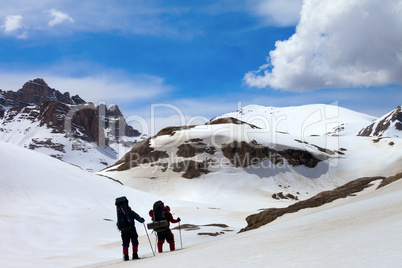 Two hikers in snow mountains