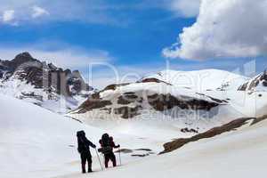 Two hikers in snow mountains