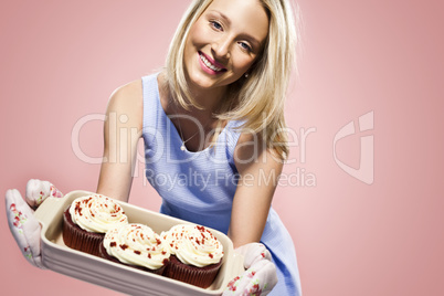 attractive blond woman holding cupcakes