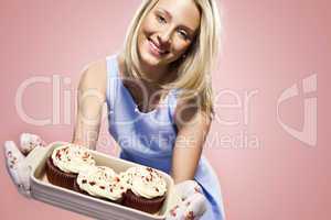attractive blond woman holding cupcakes