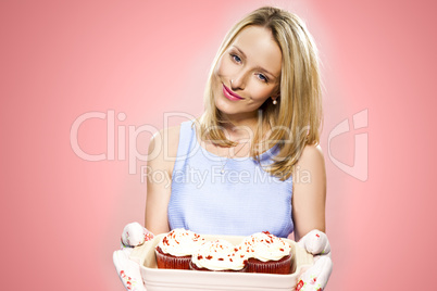 blonde woman holding cupcakes