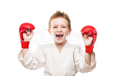 Smiling karate champion child boy gesturing for victory triumph