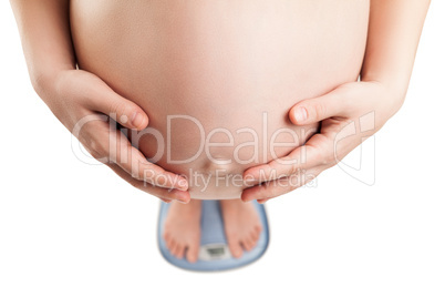 pregnant woman standing on weight balance