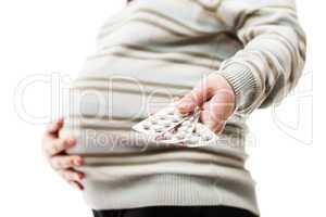 pregnant woman holding vitamin pills