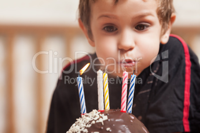 Smiling child with birthday cake candle