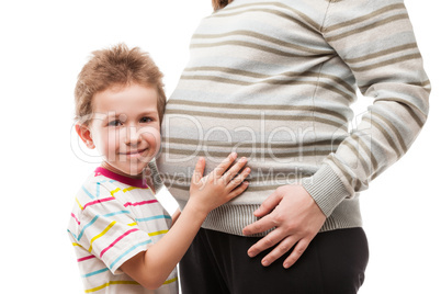 Little son touching or bonding his pregnant mother abdomen