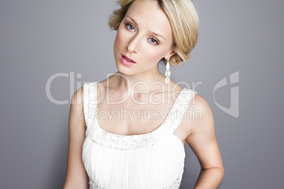 young blonde beautiful bride on grey