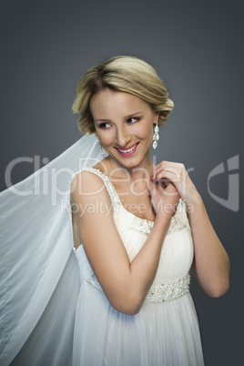 young blonde beautiful bride on grey