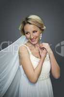 young blonde beautiful bride on grey