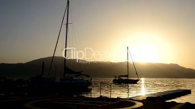 Timelaps of sunrice and beach with a view on sail yachts, Marmaris, Turkey