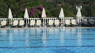The swimming pool sunbeds and flowers at luxury hotel, Fethiye, Turkey