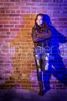 Pretty Mixed Race Young Adult Woman Against a Brick Wall