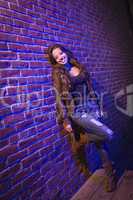 Pretty Mixed Race Young Adult Woman Against a Brick Wall