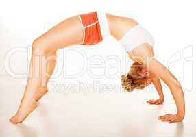 fit supple woman arching over her back