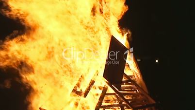 Fire pyre burning in the night handheld shot