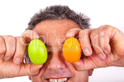 Man holding Easter eggs in front of the eyes