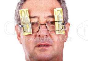 Man with banknotes behind the glasses