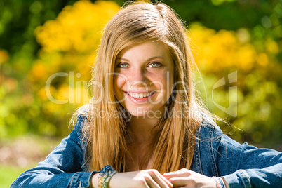 Smiling teenage girl looking at camera outdoors