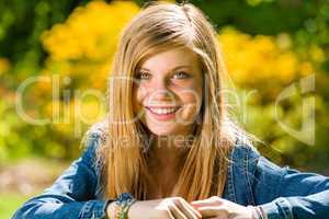 Smiling teenage girl looking at camera outdoors