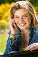 Joyful adolescent girl using her mobile phone