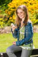 Young girl in park using her phone